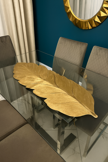 Gold leaf-shaped table runner displayed on a dining table