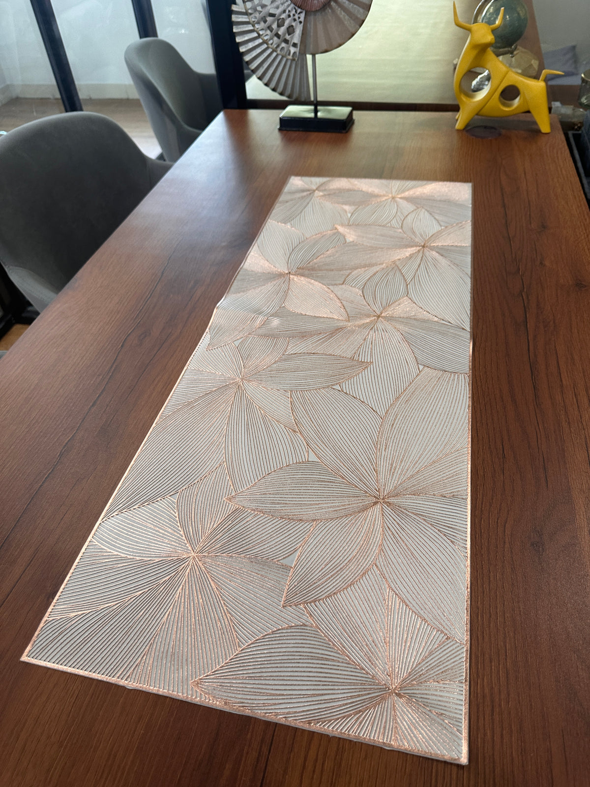 Metallic floral table runner on dining table